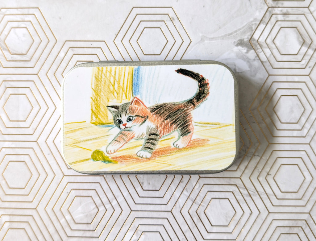 Crayon Cat and their Ball of Yarn. Catnip Tin